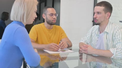 Business Professionals Discussing Data in Modern Office