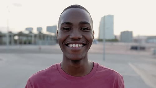 Young Man Smiling in City Close Up
