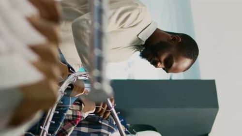 Vertical Video Female Worker Showing Clothes to Customer in Shop