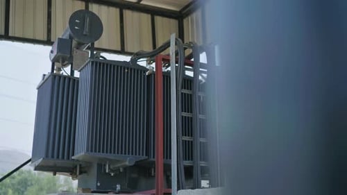 Profile view of a transformer of an industry. Day view.