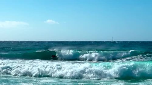 Slow motion of bodyboarder in surf in Hawaii