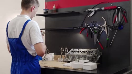 Professional Mechanic Assembles Engine at Workshop Expert Installs Pistons Liner Kit for Overhaul