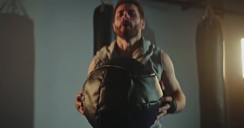 Man Doing Crossfit with Medicine Ball in Studio