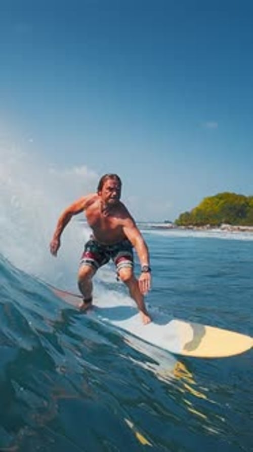 Surfer rides the wave in the ocean in the Maldives