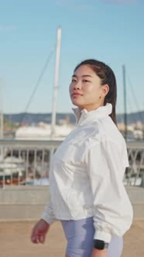 Young Asian Athlete Walking in Slow Motion Near Marina