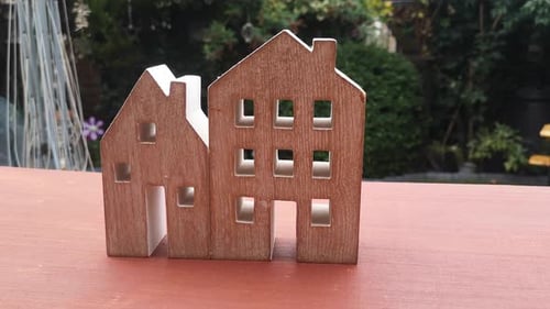 Tiny wooden house ornament in garden mortgage concept idea