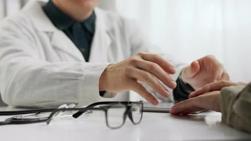 Doctor Holding Hands and Comforting Patient at Clinic