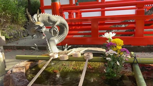 Dragon statue with typical Japanese ladle at Shinto Shrine