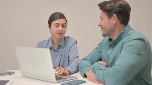 Close up of Indian woman Discussing Work with Teammate