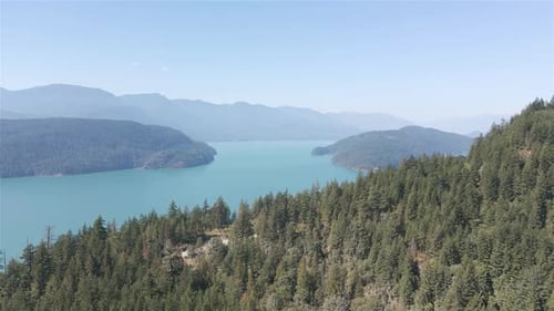 Aerial View of Lake and Green Trees in Forest Around Mountain Landscape