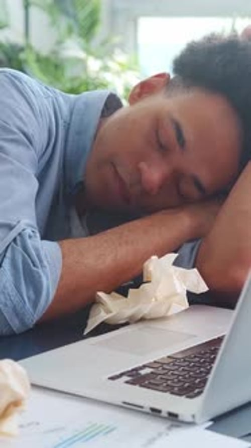 Exhausted Young Adult Asleep at Workplace Desk