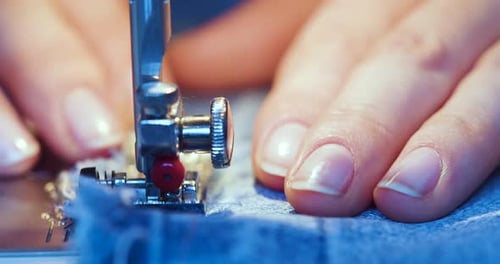 Closeup Footage of a Woman's Hands Working on a Sewing Machine