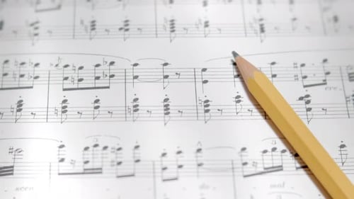 View over musical notes and pencil