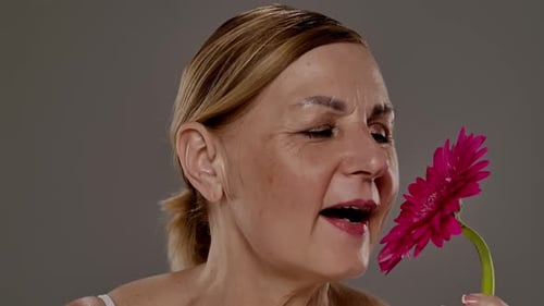 Close Up of Mature Womans Face with Flower Detail
