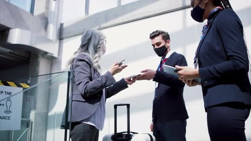 Senior woman in airport passport control during coronavirus pandemic