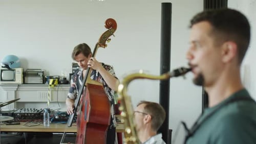 Band Plays Music Together in Bright Studio