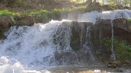 Waterfall And Amazing Nature The Rapid Flow Of The River And Splashes Of Water Drops Illuminated By
