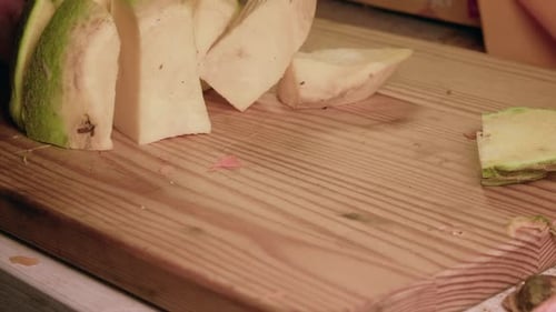 Cutting White Root Vegetable on Wood Cutting Board