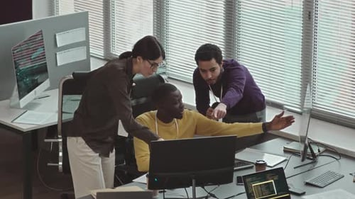 Multiracial Programmers Coworking in Office