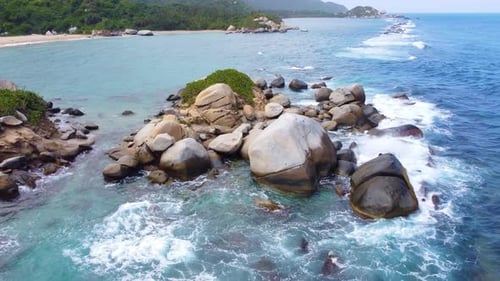 The waves of the sea of Santa Marta in Colombia breaking on the rocks of the coast