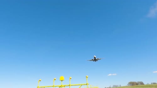 Airplane landing at the airport under clear blue skies