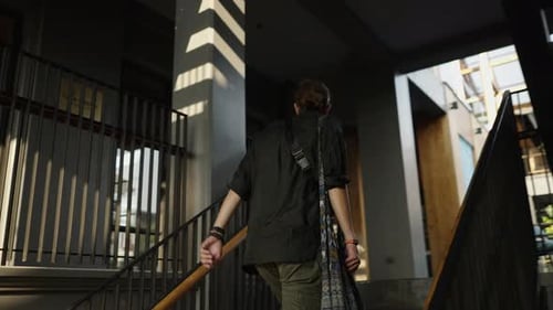 Young Man Climbs an Outdoor Staircase