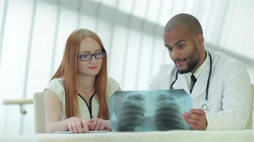Doctor and Patient Discussing X-Ray in Hospital