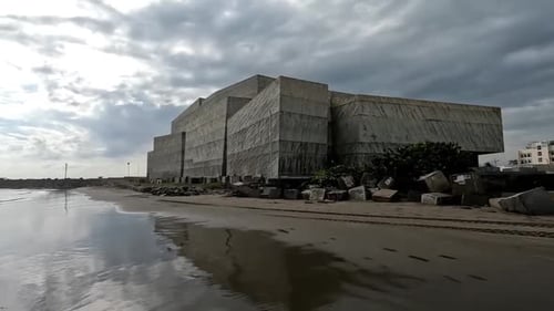 Dolly in shot of Foro Boca concert hall exterior in Boca del Rio Veracruz seen from the beach during