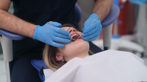 Modern Dentistry Clinic with Innovative Equipment and Treatment Dentist Checking Teeth of Woman