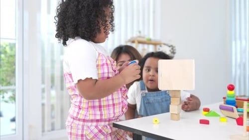 Children Playing with Wooden Blocks at a Table