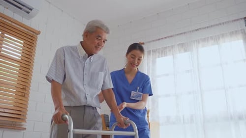Senior Man Walking with Assistance of Caregiver