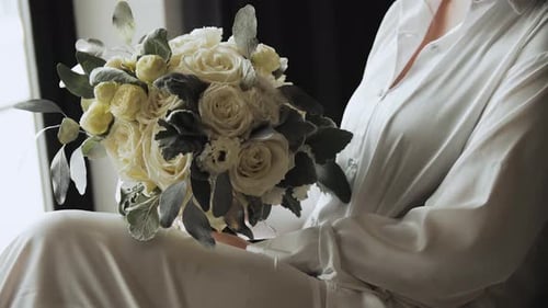 Woman Holds Beautiful Bouquet of Cream Roses