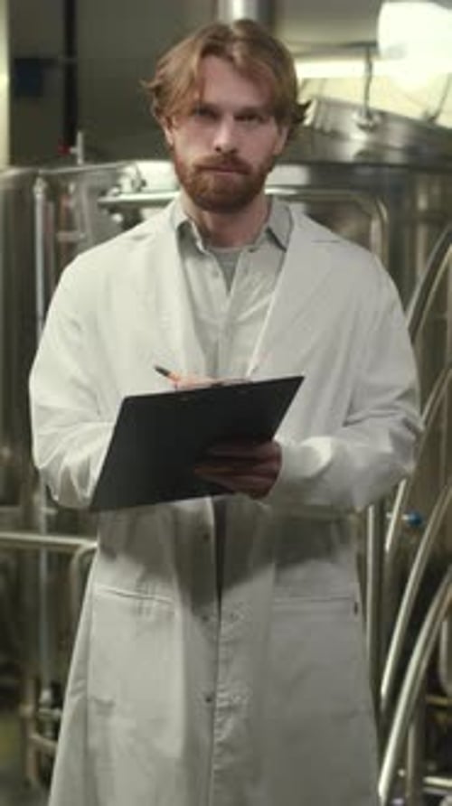 Vertical Portrait of Brew Factory Supervisor with Clipboard