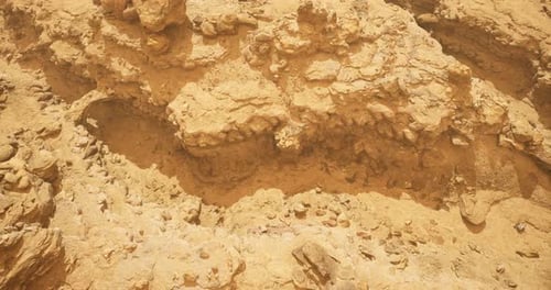 Exploring Sandy Terrain with Rock Formations in Sunny Desert Environment