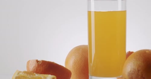Fresh Orange Juice in Glass with Sliced Oranges