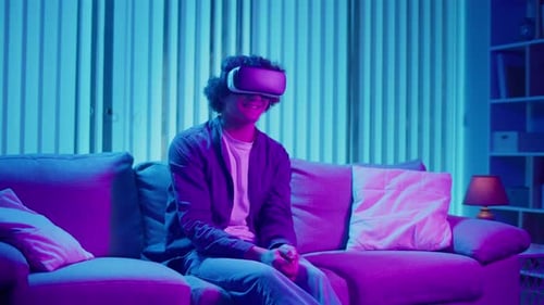 Young Adult Using Virtual Reality Headset at Home