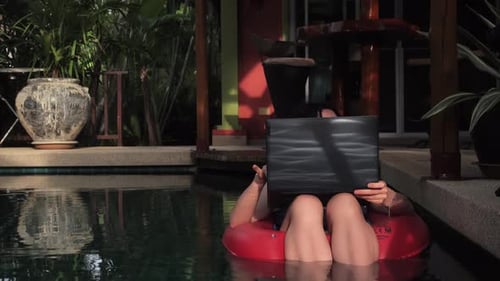 Woman Working on Laptop in Tropical Swimming Pool