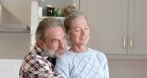 Affectionate Mature Couple Embracing in Kitchen