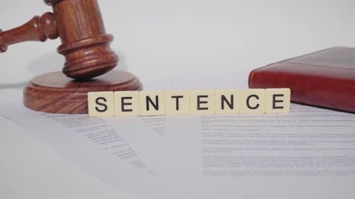Gavel and 'Sentence' Block Letters on Paper