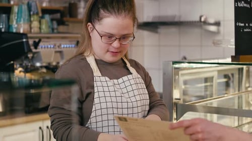 Cafe Worker Serving Customer at Counter