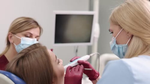 Dentist Using Intraoral Camera on Patient in Clinic
