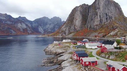 Aerial view of rorbuer cabins by sea and mountains, Norway.