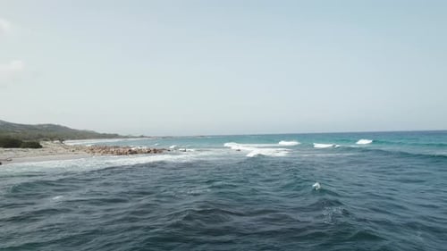 Aerial view drone over beach sea and rock coast with powerful sea waves. Beach sand and amazing sea