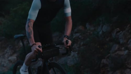 Professional Modern Cyclist on Steep Mountain Hill