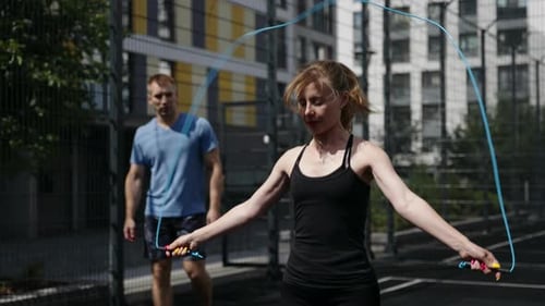 Woman Doing Jump Rope in Urban Environment
