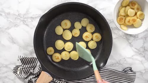 Flat Lay Step By Step Frying Mini Pancake Cereal in a Nonstick Frying Pan