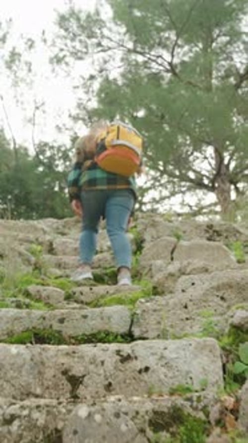Blonde Hiker Climbing Ancient Stone Steps