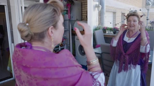 Woman Checks Her Reflection in Mirror