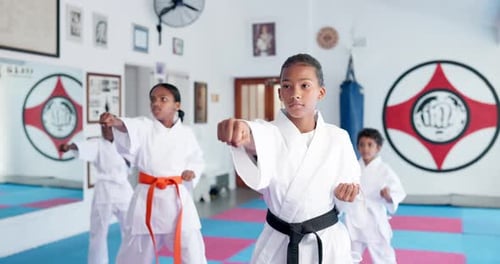 Children Practicing Karate in Bright Studio