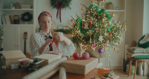 Joyful Woman Decorating Wrapping Christmas Gifts For Xmas Holidays